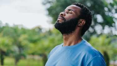 Portrait of a man breathing fresh air in nature.