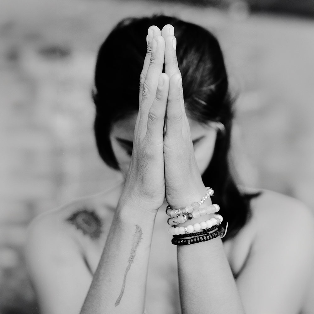 Grayscale photo of a woman meditating