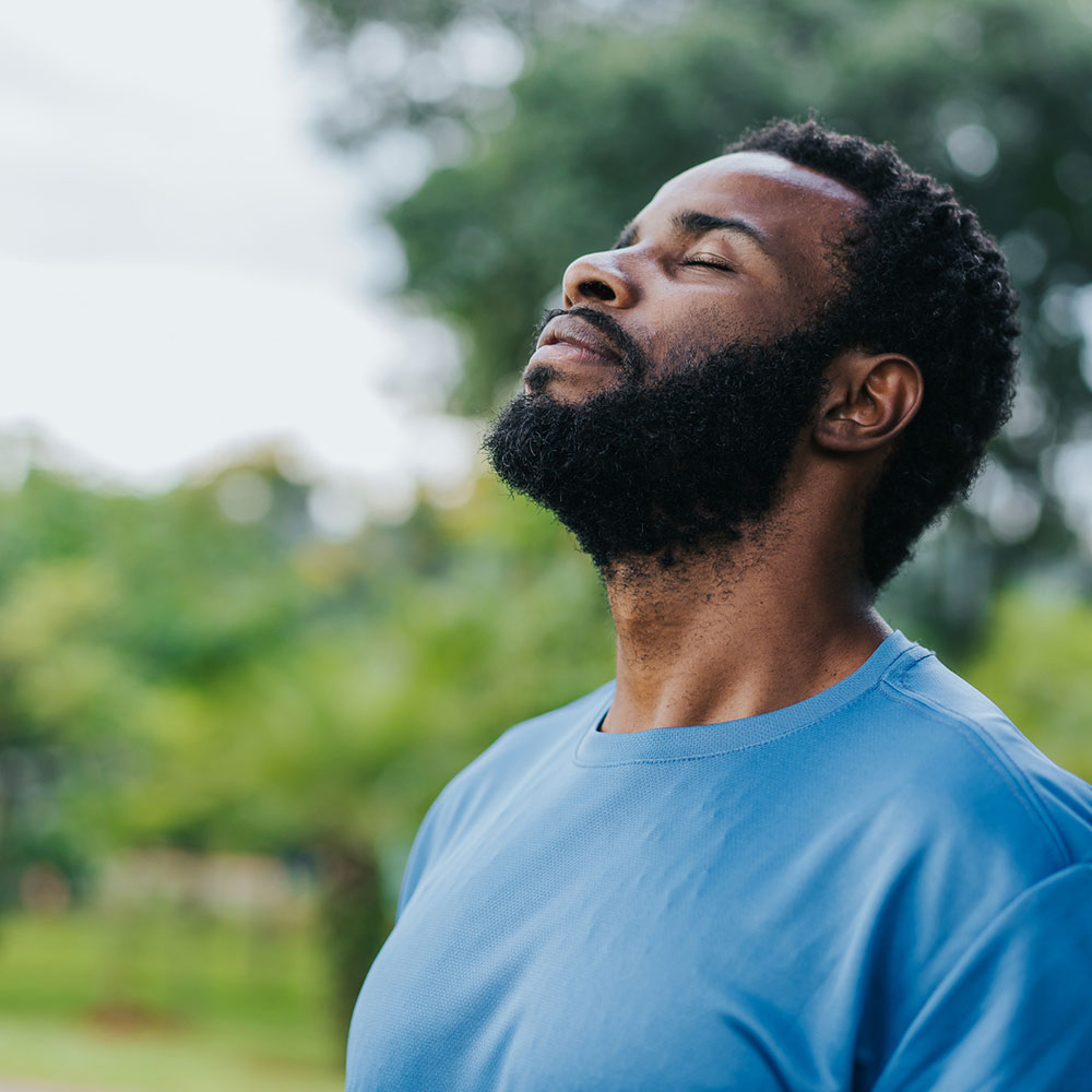 Portrait of a man breathing fresh air in nature.