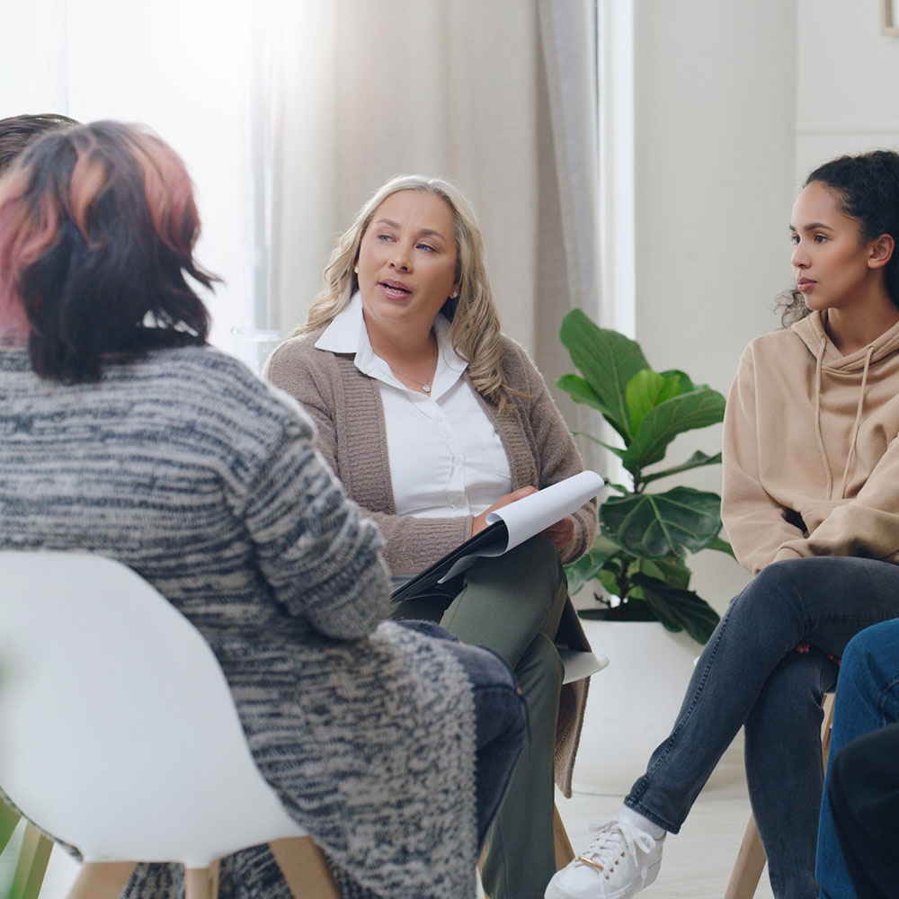 Counseling, group and psychology discussion with group of diversity people in therapy for depression, stress and anxiety. Men and women healing during psychologist meeting talking about mental health.