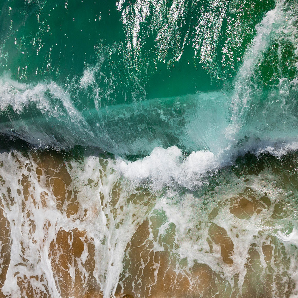 Overhead view of waves breaking on the shore