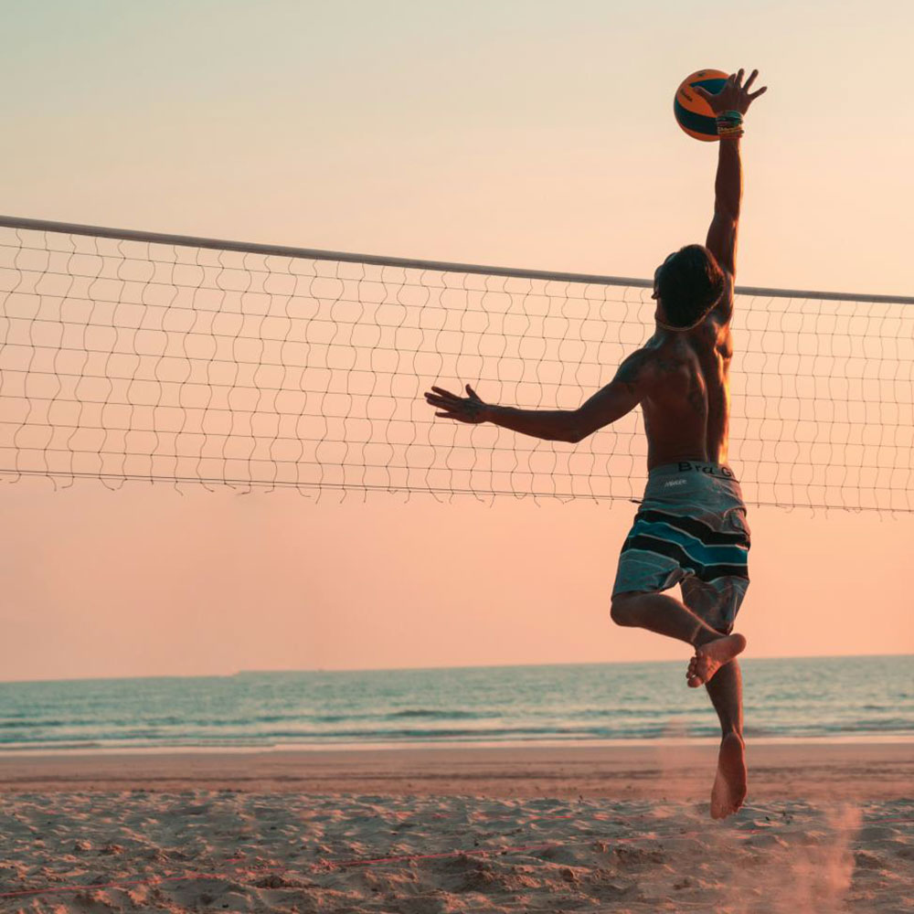 man playing volleyball on the beach